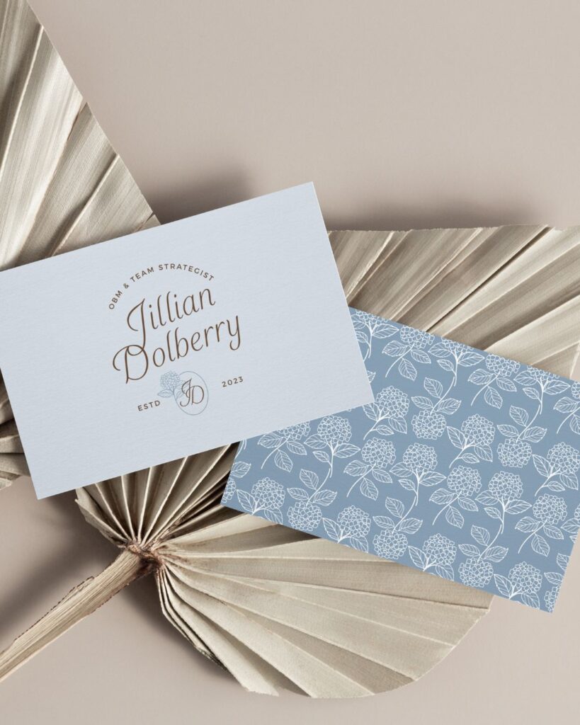 usiness card mockup showcasing Jillian Dolberry’s gentle brand design, with calming typography and floral accents for a refined, personal feel.
