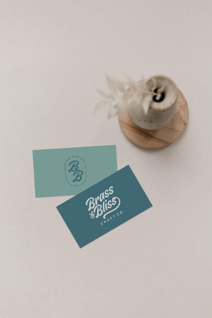 Business cards next to a vase of flowers.
