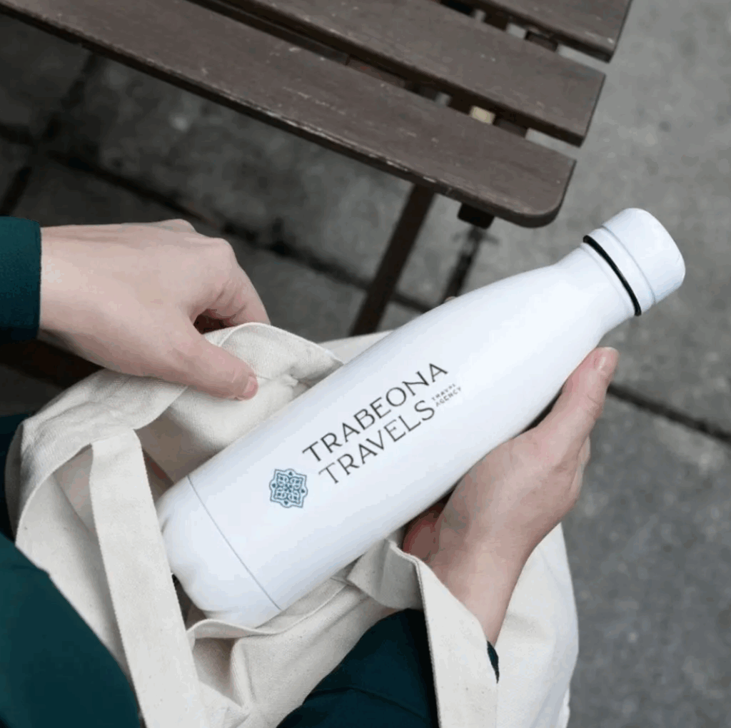 Branded reusable water bottle with logo for "Trabeona Travel"
