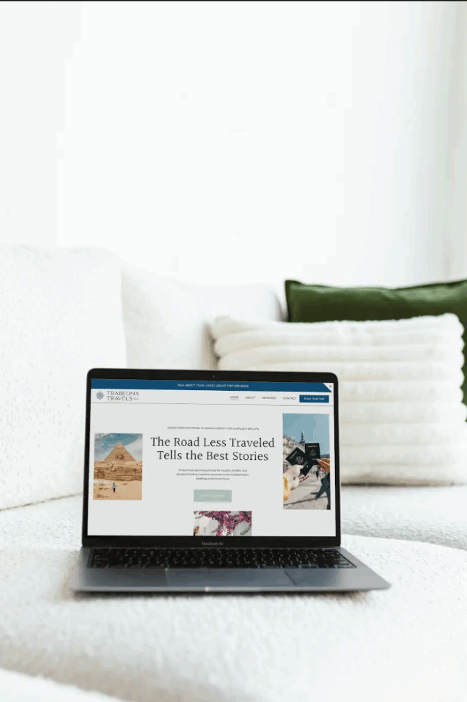 Travel brand website mocked up on a laptop sitting on a bed